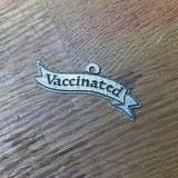 Vaccinated pewter badge